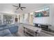 Open-concept living room with stylish hardwood floors leading to dining and stairway at 7009 Rawlins Ct, Las Vegas, NV 89128