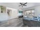 Open-concept living room with stylish hardwood floors, a ceiling fan, and a staircase at 7009 Rawlins Ct, Las Vegas, NV 89128