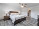 Bright main bedroom featuring hardwood floors, a ceiling fan, and two large windows at 7009 Rawlins Ct, Las Vegas, NV 89128