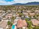 Scenic neighborhood with mature trees, and backyard pools; stunning mountain views provide a picturesque backdrop at 7427 Page Ranch Ct, Las Vegas, NV 89131