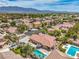 Desirable neighborhood with a private pool, meticulously maintained landscaping, and stunning mountain views in the background at 7427 Page Ranch Ct, Las Vegas, NV 89131