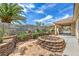 Spacious backyard with tiered landscaping and a built-in firepit area at 7427 Page Ranch Ct, Las Vegas, NV 89131