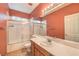 Bathroom featuring a shower with glass doors, toilet, vanity, and mirror at 7427 Page Ranch Ct, Las Vegas, NV 89131