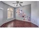 Bedroom featuring hardwood floors, a ceiling fan, geometric wall art, and shuttered windows at 7427 Page Ranch Ct, Las Vegas, NV 89131