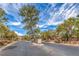 Gated community entrance with lush trees and manicured landscaping at 7427 Page Ranch Ct, Las Vegas, NV 89131