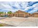 Spacious home featuring mature landscaping and a long driveway leading to the garage at 7427 Page Ranch Ct, Las Vegas, NV 89131