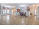 Open concept living space with tiled floors, bright natural light, and a dining area at 7427 Page Ranch Ct, Las Vegas, NV 89131