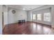 Spacious living room with hardwood flooring, recessed lighting, a ceiling fan and plantation shutters at 7427 Page Ranch Ct, Las Vegas, NV 89131