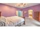 Spacious main bedroom with an ensuite bathroom, ceiling fan, and a classic wooden dresser at 7427 Page Ranch Ct, Las Vegas, NV 89131