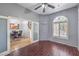 A cozy office space with hardwood floors and natural light filtering through shuttered windows at 7427 Page Ranch Ct, Las Vegas, NV 89131