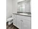 Bathroom featuring a vanity with granite countertop and wood-style flooring at 7977 Whisper Words Ave, Las Vegas, NV 89113