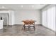 Dining area featuring wood-look flooring, modern light fixture and stainless steel appliances at 7977 Whisper Words Ave, Las Vegas, NV 89113