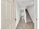 Inviting entryway featuring wood-look flooring, stairs to the upper level, and neutral walls at 7977 Whisper Words Ave, Las Vegas, NV 89113