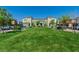 Attractive community green space offers lawn, shade trees, benches, and well-maintained townhouse exteriors at 7977 Whisper Words Ave, Las Vegas, NV 89113
