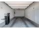Clean, spacious one-car garage interior with water filter system and ample room for parking and storage at 7977 Whisper Words Ave, Las Vegas, NV 89113