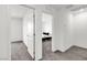 Hallway showcases doorway into a bedroom with patterned bedding at 7977 Whisper Words Ave, Las Vegas, NV 89113
