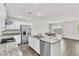 Open kitchen with stainless steel appliances, granite countertops, and wood floors at 7977 Whisper Words Ave, Las Vegas, NV 89113