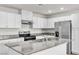 New kitchen features granite countertops, stainless appliances, and white cabinets at 7977 Whisper Words Ave, Las Vegas, NV 89113
