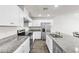 Modern kitchen features granite countertops and stainless steel appliances and wood floors at 7977 Whisper Words Ave, Las Vegas, NV 89113
