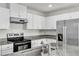 Granite countertops and stainless appliances in a modern kitchen at 7977 Whisper Words Ave, Las Vegas, NV 89113