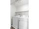 Laundry room featuring modern, white washer and dryer at 7977 Whisper Words Ave, Las Vegas, NV 89113