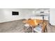 Open-concept living room and kitchen with wood floors, stainless steel appliances, and white cabinets at 7977 Whisper Words Ave, Las Vegas, NV 89113