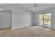 Spacious bedroom with a ceiling fan and sliding glass door leading to a balcony at 8000 Badura Ave # 2174, Las Vegas, NV 89113