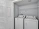 Laundry closet with side by side white washer and dryer at 8000 Badura Ave # 2174, Las Vegas, NV 89113