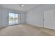Bright living room with sliding glass doors to balcony and an entrance door on the side at 8000 Badura Ave # 2174, Las Vegas, NV 89113