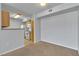 Cozy living room with a partial view of the kitchen featuring standard appliances at 8000 Badura Ave # 2174, Las Vegas, NV 89113