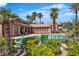 Resort-style community pool featuring lounge chairs, lush landscaping, and palm trees for a relaxing atmosphere at 8000 Badura Ave # 2174, Las Vegas, NV 89113