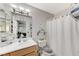 Well-lit bathroom featuring a vanity, toilet, and shower with an elephant-themed shower curtain at 8450 Alta Dr # 204, Las Vegas, NV 89145