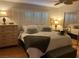 Comfortable bedroom with a plush bed, soft lighting, and mirrored closet at 8450 Alta Dr # 204, Las Vegas, NV 89145