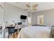 Bright bedroom featuring a ceiling fan, wall-mounted TV, and a cozy white comforter at 8450 Alta Dr # 204, Las Vegas, NV 89145