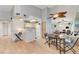 Inviting dining area with wood floors and a ceiling fan, flowing seamlessly into the kitchen at 8450 Alta Dr # 204, Las Vegas, NV 89145