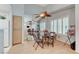 Bright dining area with a mirrored wall, wood floors, and a ceiling fan at 8450 Alta Dr # 204, Las Vegas, NV 89145