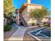 Well-maintained two-story condo building with landscaped walkway and mature trees at 8450 Alta Dr # 204, Las Vegas, NV 89145