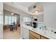 Open kitchen with wood cabinets providing a view of the living and dining areas at 8450 Alta Dr # 204, Las Vegas, NV 89145