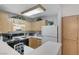 Compact kitchen with ample cabinet space and essential appliances for convenient meal preparation at 8450 Alta Dr # 204, Las Vegas, NV 89145