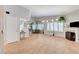 Bright living room features a fireplace, wood floors, and natural light from shuttered windows at 8450 Alta Dr # 204, Las Vegas, NV 89145