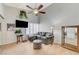 Spacious living room with a vaulted ceiling, ceiling fan, and comfortable gray sofa at 8450 Alta Dr # 204, Las Vegas, NV 89145