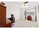 Bright bedroom featuring a ceiling fan, desk, and a window offering natural light at 9050 W Tropicana Ave # 1170, Las Vegas, NV 89147