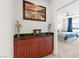 Transitional bedroom with a scenic wall art piece and a glimpse into the bright bedroom with great views at 9050 W Tropicana Ave # 1170, Las Vegas, NV 89147