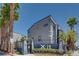 Modern building exterior featuring palm trees and sleek architectural design at 9050 W Tropicana Ave # 1170, Las Vegas, NV 89147