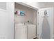 Well-equipped laundry room with washer, dryer, and ironing board neatly stored in a closet at 9050 W Tropicana Ave # 1170, Las Vegas, NV 89147