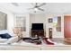 Living room with media center, neutral walls, and a cozy rocking chair by the bright window at 9050 W Tropicana Ave # 1170, Las Vegas, NV 89147