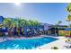 Inviting community pool featuring sparkling water, palm trees, and comfortable seating for outdoor enjoyment at 9050 W Tropicana Ave # 1170, Las Vegas, NV 89147