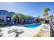 Stunning community pool featuring lounge chairs, lush palm trees, and a colorful clubhouse for relaxing summer days at 9050 W Tropicana Ave # 1170, Las Vegas, NV 89147