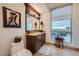 Bathroom with framed mirror, decorative lamps, and window offering city views at 9103 Alta Drive Dr # 407, Las Vegas, NV 89145