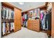 Spacious walk-in closet with custom wood shelving and ample storage space for clothes and accessories at 9103 Alta Drive Dr # 407, Las Vegas, NV 89145